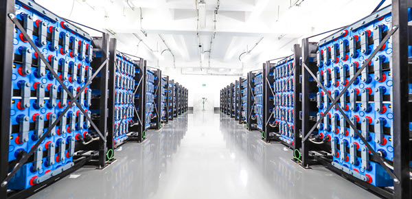 A battery room with rows of battery banksd