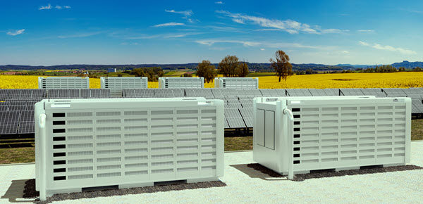 A solar energy project with battery storage in the foreground